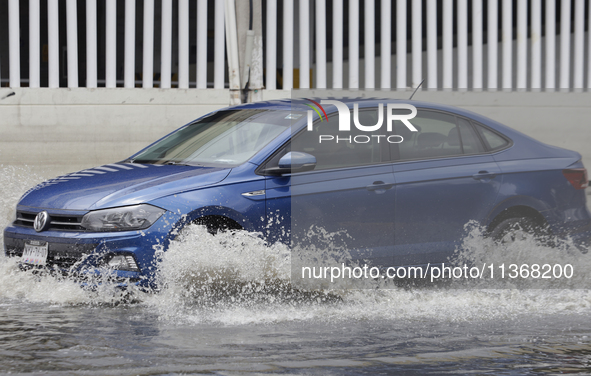 Cars are trying to drive outside a flooded shopping mall in Ecatepec, State of Mexico, due to the rains during the last few days. 