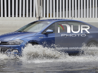 Cars are trying to drive outside a flooded shopping mall in Ecatepec, State of Mexico, due to the rains during the last few days. (