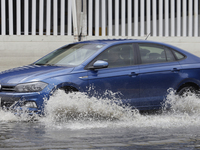 Cars are trying to drive outside a flooded shopping mall in Ecatepec, State of Mexico, due to the rains during the last few days. (