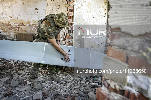 An aerial reconnaissance man of the 148th separate artillery brigade of the Ukrainian Air Assault Forces is assembling a drone before launch...