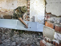 An aerial reconnaissance man of the 148th separate artillery brigade of the Ukrainian Air Assault Forces is assembling a drone before launch...