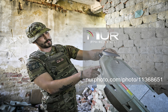 An aerial reconnaissance man of the 148th separate artillery brigade of the Ukrainian Air Assault Forces is assembling a drone before launch...