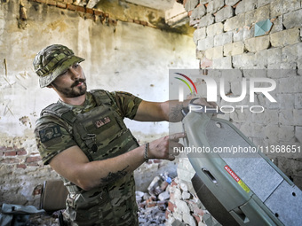 An aerial reconnaissance man of the 148th separate artillery brigade of the Ukrainian Air Assault Forces is assembling a drone before launch...