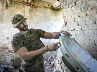 An aerial reconnaissance man of the 148th separate artillery brigade of the Ukrainian Air Assault Forces is assembling a drone before launch...