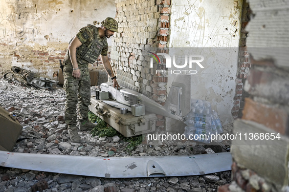 An aerial reconnaissance man of the 148th separate artillery brigade of the Ukrainian Air Assault Forces is assembling a drone before launch...