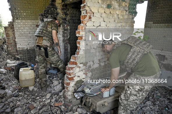 Aerial reconnaissance men of the 148th separate artillery brigade of the Ukrainian Air Assault Forces are assembling a drone before launch i...