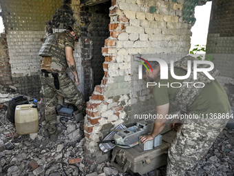 Aerial reconnaissance men of the 148th separate artillery brigade of the Ukrainian Air Assault Forces are assembling a drone before launch i...