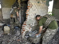 Aerial reconnaissance men of the 148th separate artillery brigade of the Ukrainian Air Assault Forces are assembling a drone before launch i...