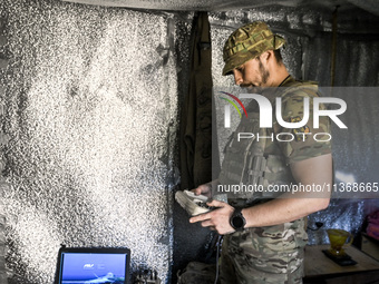 An aerial reconnaissance man of the 148th separate artillery brigade of the Ukrainian Air Assault Forces is performing combat work in Donets...