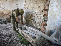 An aerial reconnaissance man of the 148th separate artillery brigade of the Ukrainian Air Assault Forces is assembling a drone before launch...