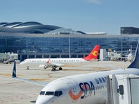 A passenger plane is sliding into the parking stand at the T2 terminal of Yantai Penglai International Airport in Yantai, China, on June 28,...