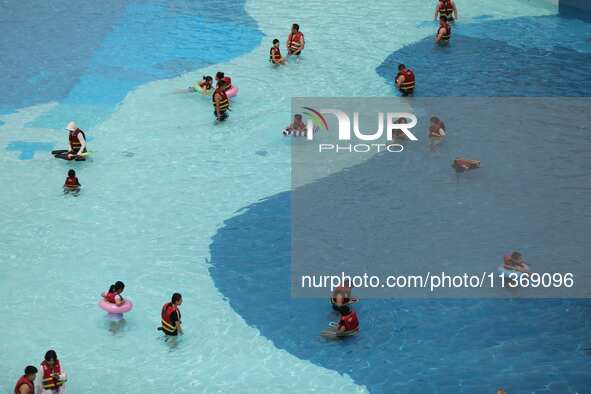 People are playing in the water at Longcheng Happy Water World Scenic spot in Chengde, China, on June 29, 2024. 