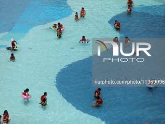 People are playing in the water at Longcheng Happy Water World Scenic spot in Chengde, China, on June 29, 2024. (