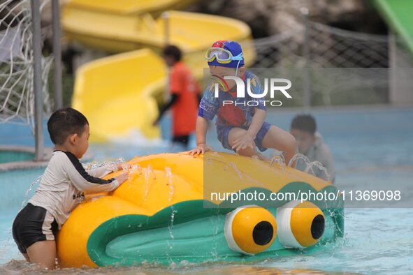 People are playing in the water at Longcheng Happy Water World Scenic spot in Chengde, China, on June 29, 2024. 