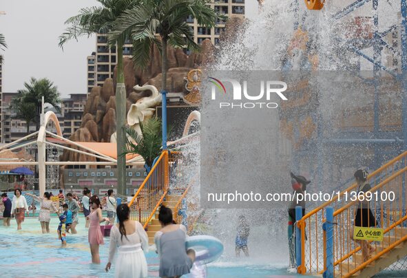 People are playing in the water at Longcheng Happy Water World Scenic spot in Chengde, China, on June 29, 2024. 