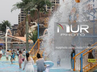 People are playing in the water at Longcheng Happy Water World Scenic spot in Chengde, China, on June 29, 2024. (