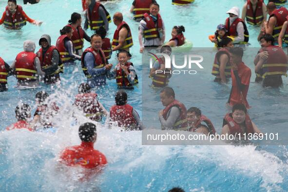 People are playing in the water at Longcheng Happy Water World Scenic spot in Chengde, China, on June 29, 2024. 