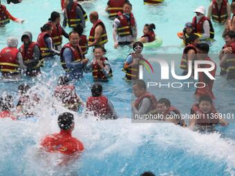 People are playing in the water at Longcheng Happy Water World Scenic spot in Chengde, China, on June 29, 2024. (