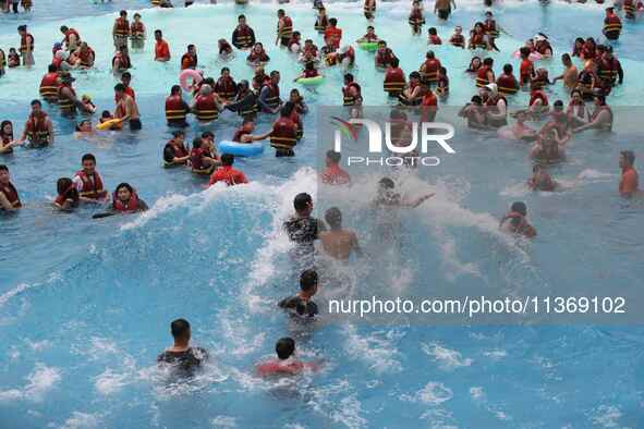 People are playing in the water at Longcheng Happy Water World Scenic spot in Chengde, China, on June 29, 2024. 