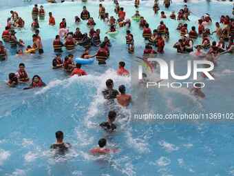 People are playing in the water at Longcheng Happy Water World Scenic spot in Chengde, China, on June 29, 2024. (