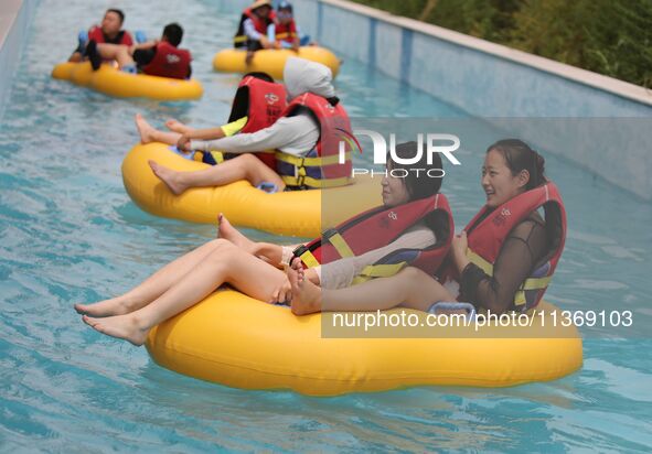 People are playing in the water at Longcheng Happy Water World Scenic spot in Chengde, China, on June 29, 2024. 