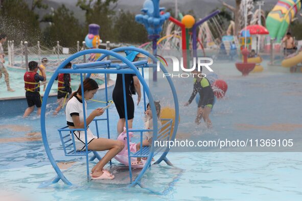 People are playing in the water at Longcheng Happy Water World Scenic spot in Chengde, China, on June 29, 2024. 