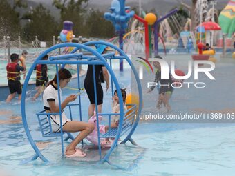 People are playing in the water at Longcheng Happy Water World Scenic spot in Chengde, China, on June 29, 2024. (