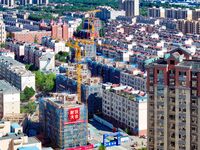 Builders are working at the construction site of a house renovation project in Baotou, Inner Mongolia, China, on June 29, 2024. (