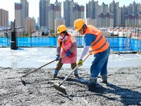 Builders are working at the construction site of a house renovation project in Baotou, Inner Mongolia, China, on June 29, 2024. (