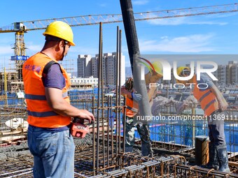 Builders are working at the construction site of a house renovation project in Baotou, Inner Mongolia, China, on June 29, 2024. (