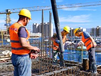 Builders are working at the construction site of a house renovation project in Baotou, Inner Mongolia, China, on June 29, 2024. (