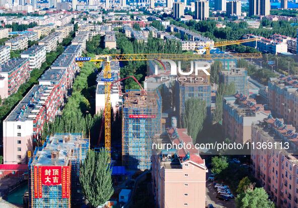 Builders are working at the construction site of a house renovation project in Baotou, Inner Mongolia, China, on June 29, 2024. 