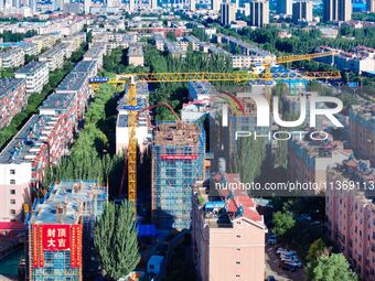 Builders are working at the construction site of a house renovation project in Baotou, Inner Mongolia, China, on June 29, 2024. (