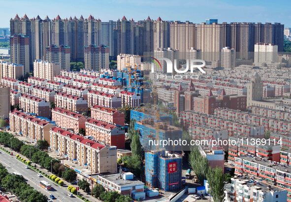 Builders are working at the construction site of a house renovation project in Baotou, Inner Mongolia, China, on June 29, 2024. 