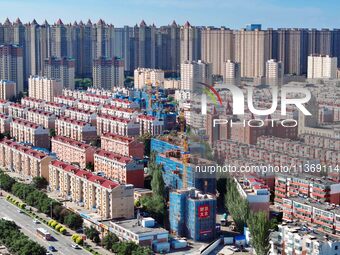 Builders are working at the construction site of a house renovation project in Baotou, Inner Mongolia, China, on June 29, 2024. (