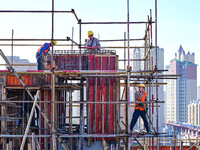 Builders are working at the construction site of a house renovation project in Baotou, Inner Mongolia, China, on June 29, 2024. (