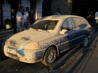 Dust is covering a car during a search and rescue effort at an apartment block hit by a Russian missile in Dnipro, Ukraine, on June 28, 2024...