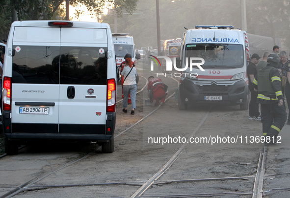 Ambulances are being pictured during a search and rescue effort at an apartment block hit by a Russian missile in Dnipro, Ukraine, on June 2...