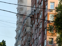 A firefighter in an aerial work platform is carrying out a search and rescue effort at the apartment block hit by the Russian missile in Dni...