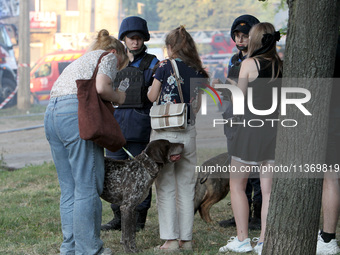 Rescuers are staying by people outside an apartment block hit by a Russian missile in Dnipro, Ukraine, on June 28, 2024. Russian troops are...