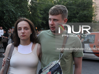 A man and woman are participating in a search and rescue effort at an apartment block hit by a Russian missile in Dnipro, Ukraine, on June 2...