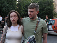 A man and woman are participating in a search and rescue effort at an apartment block hit by a Russian missile in Dnipro, Ukraine, on June 2...