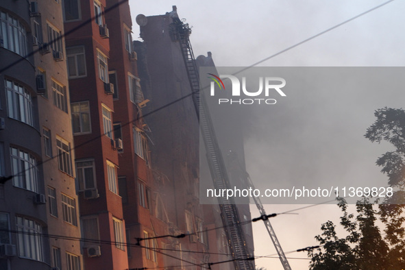 Firefighters in aerial work platforms are carrying out a search and rescue effort at an apartment block hit by a Russian missile in Dnipro,...