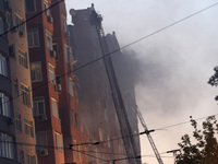 Firefighters in aerial work platforms are carrying out a search and rescue effort at an apartment block hit by a Russian missile in Dnipro,...