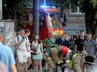 Onlookers are watching a search and rescue effort at an apartment block hit by a Russian missile in Dnipro, Ukraine, on June 28, 2024. Russi...