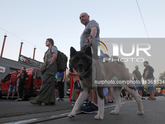 A man and a dog are participating in a search and rescue effort at an apartment block hit by a Russian missile in Dnipro, Ukraine, on June 2...