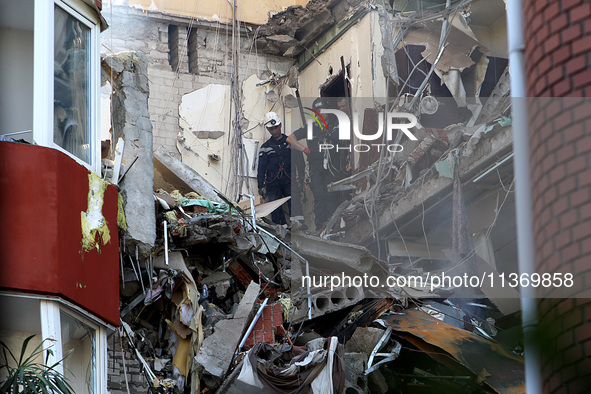 Rescuers are carrying out a search and rescue effort at an apartment block damaged by the June 28 Russian missile attack in Dnipro, Ukraine,...