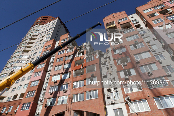 A crane is being used during a search and rescue effort at an apartment block damaged by the June 28 Russian missile attack in Dnipro, Ukrai...