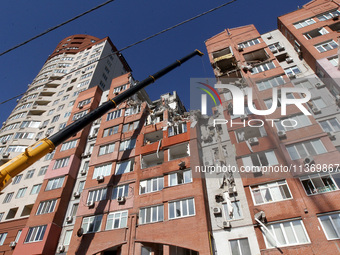 A crane is being used during a search and rescue effort at an apartment block damaged by the June 28 Russian missile attack in Dnipro, Ukrai...