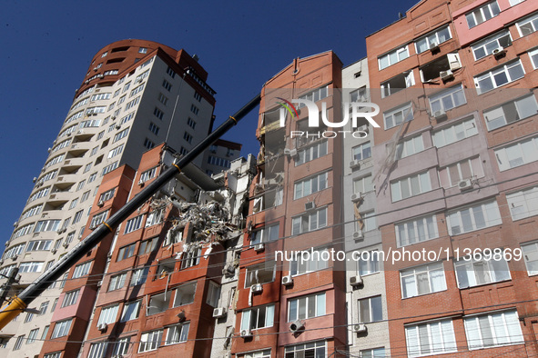 A crane is being used during a search and rescue effort at an apartment block damaged by the June 28 Russian missile attack in Dnipro, Ukrai...